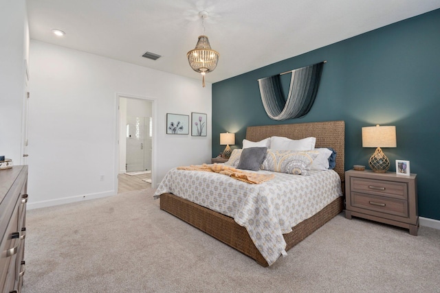 14175 SW Harker St, Port Saint Lucie, FL 34987 - bedroom with light carpet, baseboards, a chandelier, and ensuite bathroom