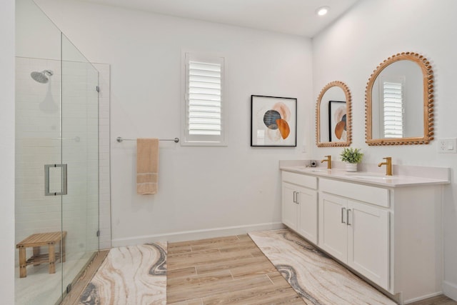 14175 SW Harker St, Port Saint Lucie, FL 34987 - bathroom with a shower stall, plenty of natural light, wood finished floors, double vanity, and recessed lighting