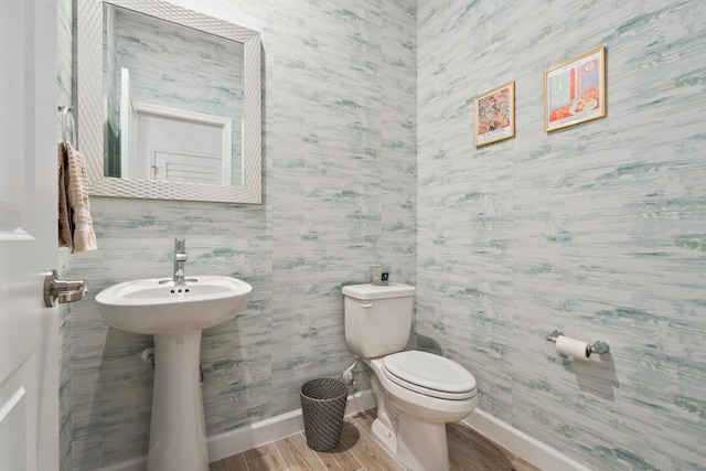 14175 SW Harker St, Port Saint Lucie, FL 34987 - half bathroom featuring baseboards, toilet, wood finished floors, and wallpapered walls