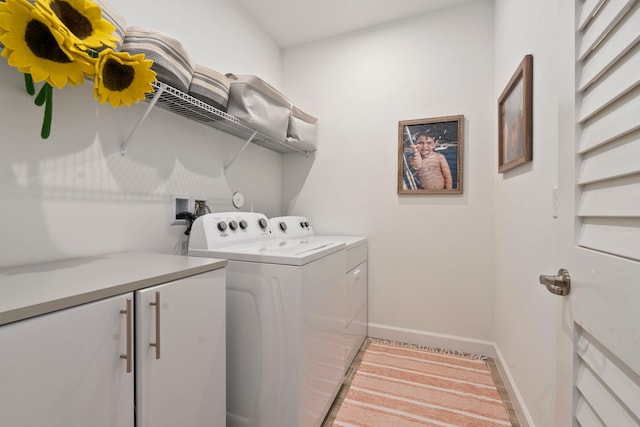 14175 SW Harker St, Port Saint Lucie, FL 34987 - laundry room with washer and clothes dryer, baseboards, and cabinet space