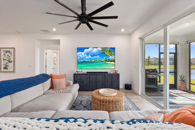 14175 SW Harker St, Port Saint Lucie, FL 34987 - living room featuring light wood-type flooring, ceiling fan, recessed lighting, and baseboards
