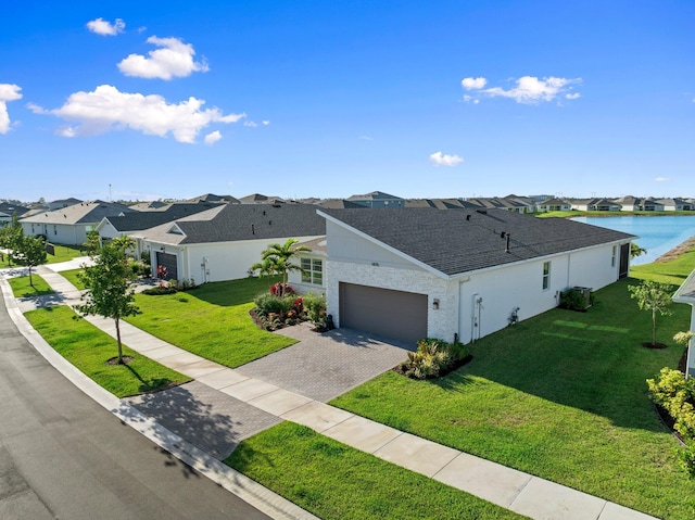 14175 SW Harker St, Port Saint Lucie, FL 34987 - view of front of home featuring a residential view, an attached garage, roof with shingles, decorative driveway, and a front yard