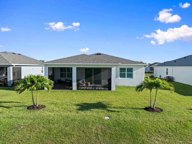 14175 SW Harker St, Port Saint Lucie, FL 34987 - rear view of house with a yard, stucco siding, a sunroom, and roof with shingles