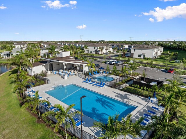 14175 SW Harker St, Port Saint Lucie, FL 34987 - community pool featuring a patio, a residential view, and a water view
