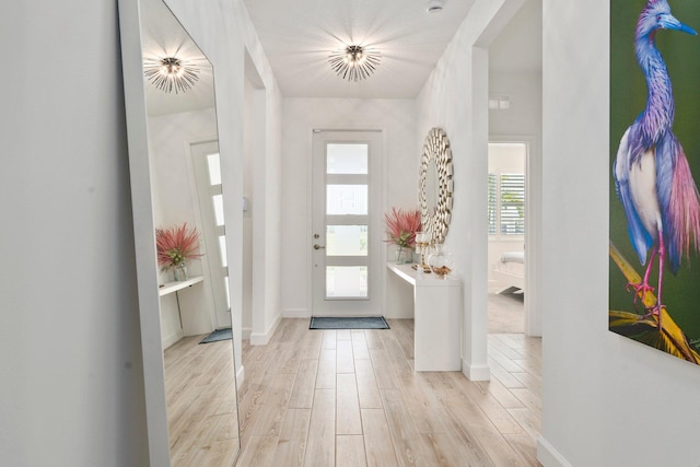 14175 SW Harker St, Port Saint Lucie, FL 34987 - foyer with light wood-type flooring and baseboards