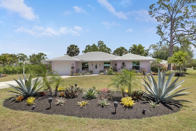 18315 SE Courtview Cir, Tequesta, FL 33469 - single story home with an attached garage, a front lawn, stucco siding, and metal roof