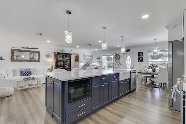 18315 SE Courtview Cir, Tequesta, FL 33469 - kitchen featuring a sink, light countertops, stainless steel appliances, open floor plan, and recessed lighting