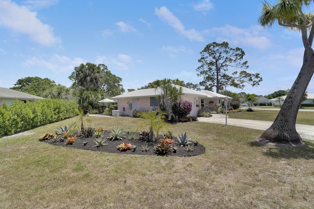 18315 SE Courtview Cir, Tequesta, FL 33469 - view of yard featuring driveway and a carport