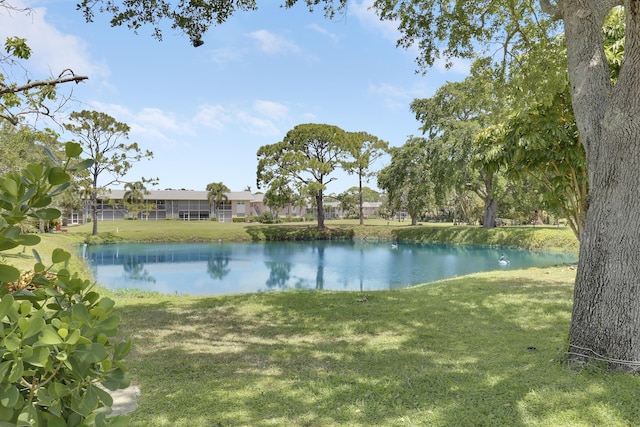 18315 SE Courtview Cir, Tequesta, FL 33469 - rear view of house with a lawn and metal roof