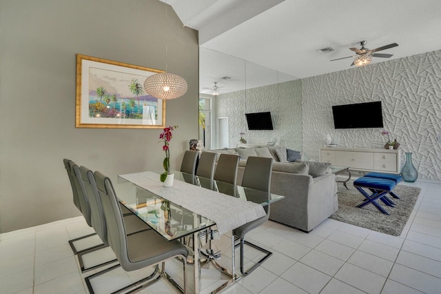 dining space with visible vents, ceiling fan, tile patterned floors, and wallpapered walls