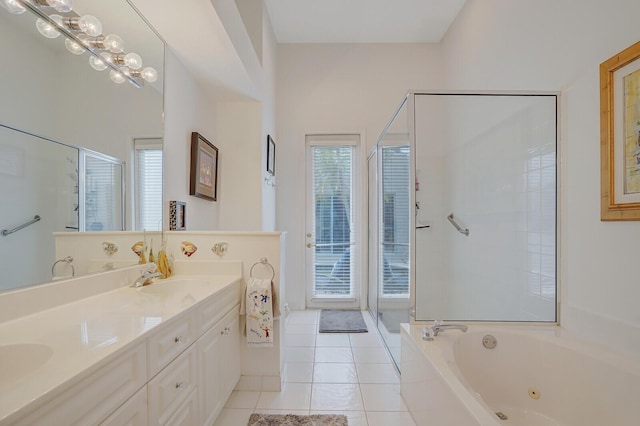bathroom with double vanity, a tub with jets, tile patterned floors, a sink, and a stall shower