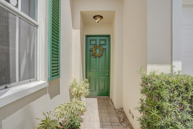 entrance to property with stucco siding