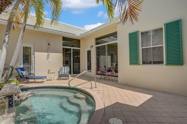 back of house featuring a patio, an outdoor pool, and stucco siding