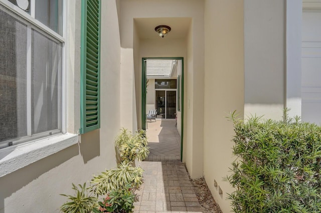doorway to property featuring stucco siding