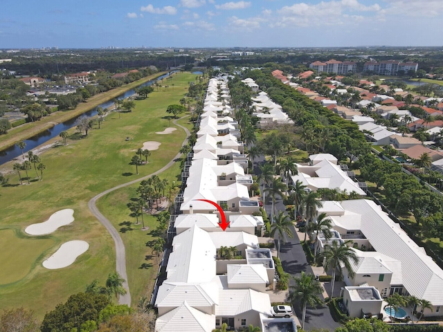 aerial view featuring a water view, view of golf course, and a residential view