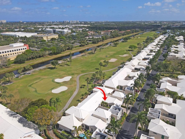 aerial view featuring a water view, view of golf course, and a residential view