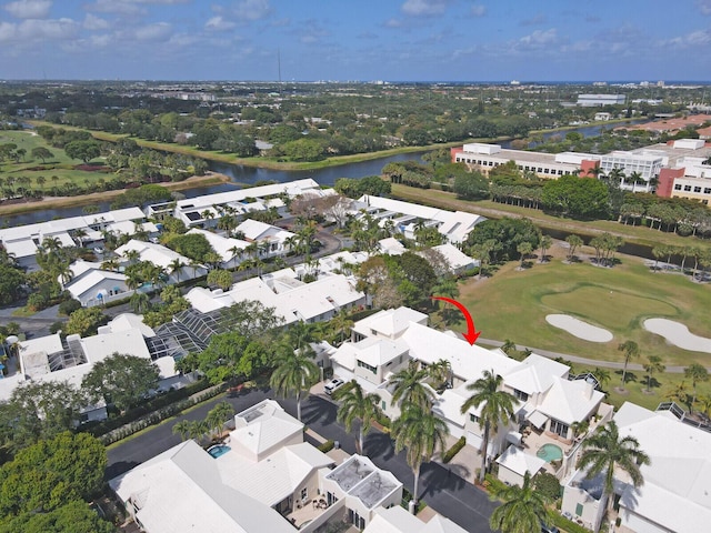 bird's eye view featuring a water view, view of golf course, and a residential view