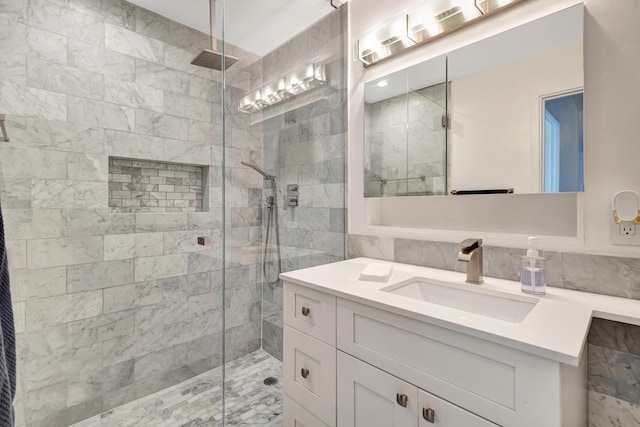 44 Cocoanut Row Unit 507A, Palm Beach, FL 33480 - bathroom with a shower stall, vanity, and tile walls