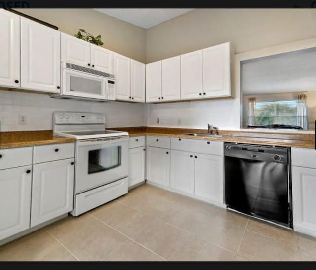13135 Chadwick Ct Unit 7, Wellington, FL 33414 - kitchen featuring white appliances, a sink, white cabinetry, and light tile patterned floors