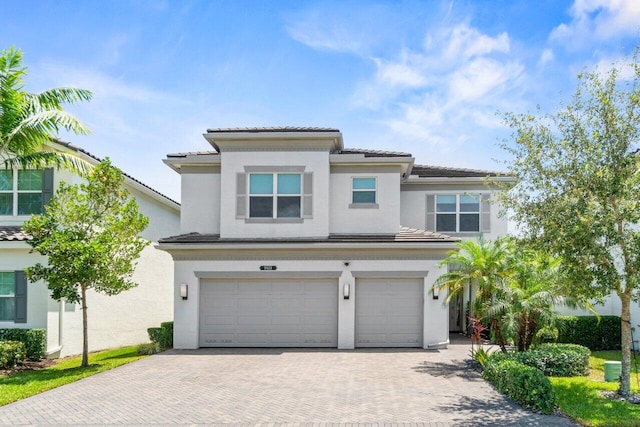 9610 Sterling Shores St, Delray Beach, FL 33446 - view of front of house with a garage, decorative driveway, a tile roof, and stucco siding