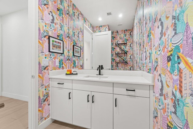 9610 Sterling Shores St, Delray Beach, FL 33446 - bathroom with wallpapered walls, vanity, baseboards, wood finished floors, and recessed lighting
