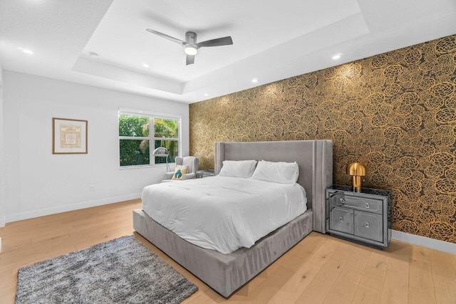 9610 Sterling Shores St, Delray Beach, FL 33446 - bedroom featuring a tray ceiling, baseboards, light wood-type flooring, recessed lighting, and a ceiling fan