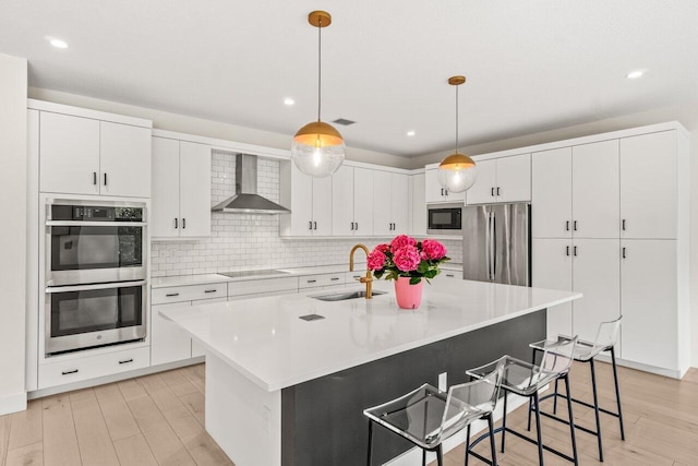 9610 Sterling Shores St, Delray Beach, FL 33446 - kitchen with wall chimney range hood, stainless steel appliances, a sink, light countertops, and white cabinetry