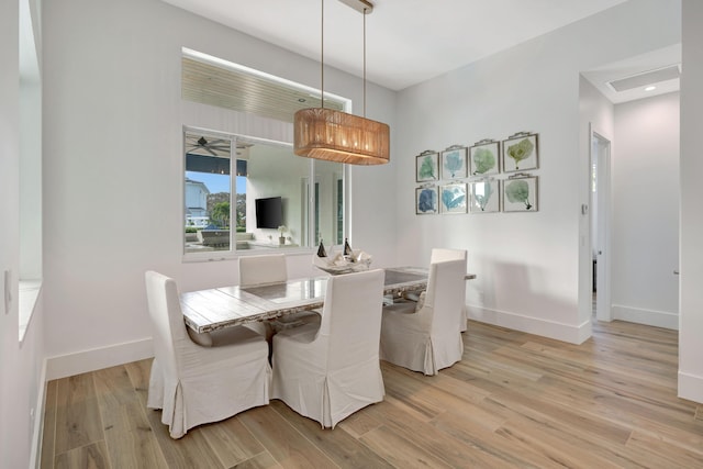 dining room with baseboards, recessed lighting, and light wood-style flooring