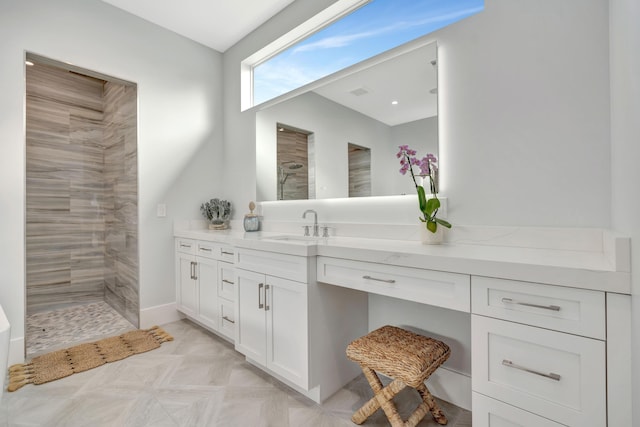 bathroom featuring walk in shower and vanity