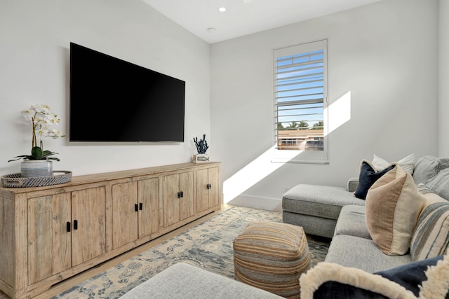 living area featuring recessed lighting and baseboards