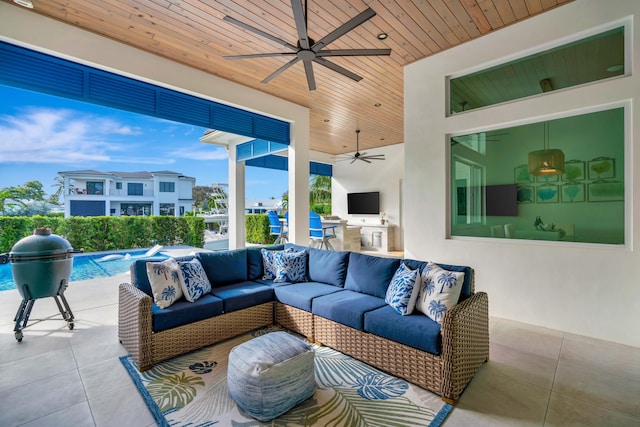 view of patio featuring an outdoor hangout area, a ceiling fan, a fenced in pool, and exterior kitchen