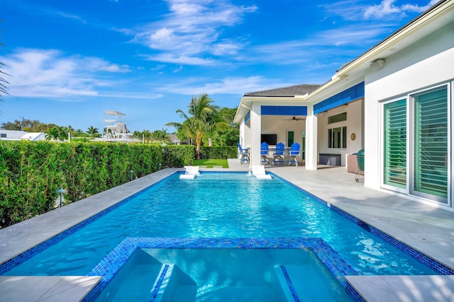 view of swimming pool featuring a patio, a fenced backyard, ceiling fan, and a pool with connected hot tub