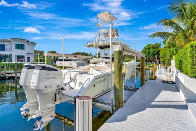 view of dock with boat lift and a water view