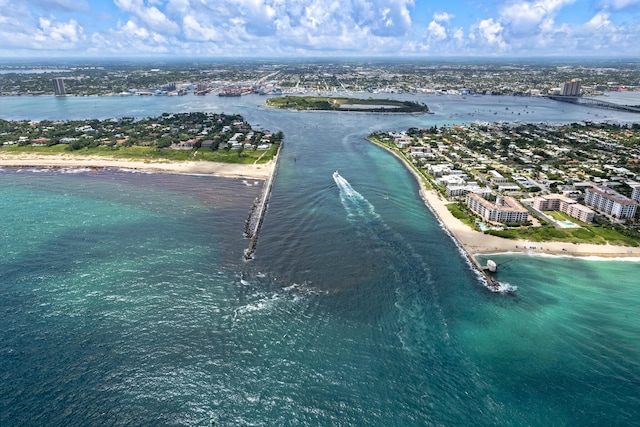 birds eye view of property with a view of city, a water view, and a beach view