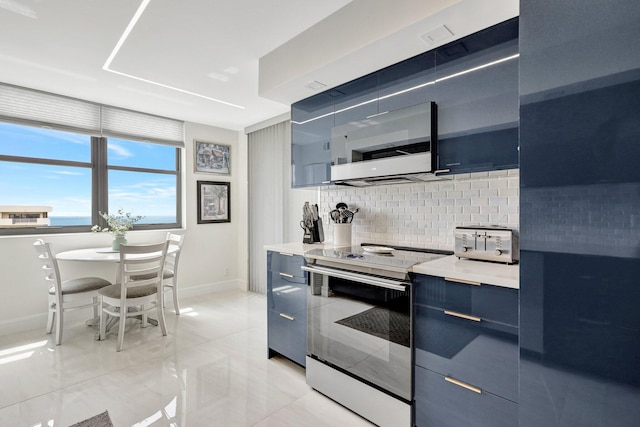 4600 S Ocean Blvd Unit 1003, Highland Beach, FL 33487 - kitchen featuring electric range, white microwave, modern cabinets, baseboards, and tasteful backsplash