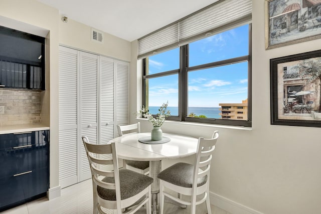 4600 S Ocean Blvd Unit 1003, Highland Beach, FL 33487 - dining area featuring baseboards and a water view