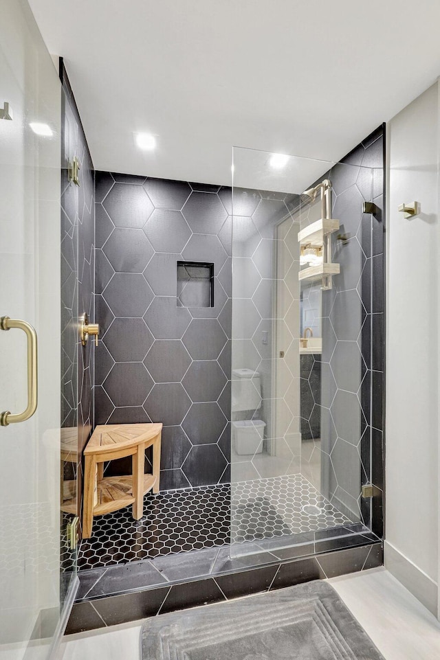 full bath featuring recessed lighting, a tile shower, and tile patterned flooring