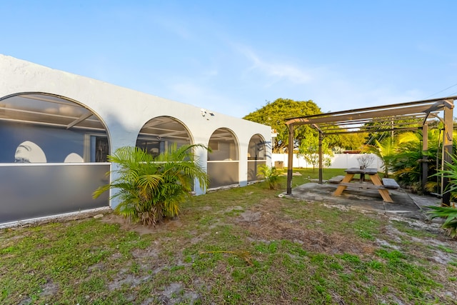 view of yard with a fenced backyard, a pergola, and a patio area