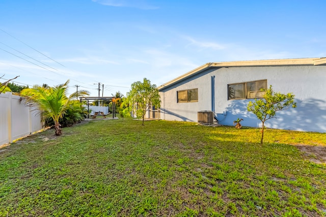 view of yard featuring central air condition unit and a fenced backyard