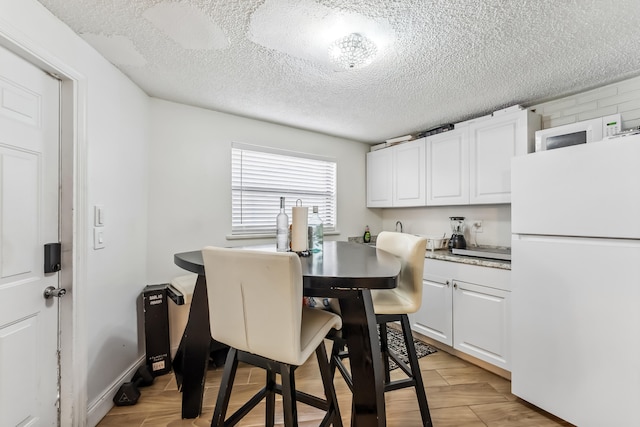 dining area with a textured ceiling