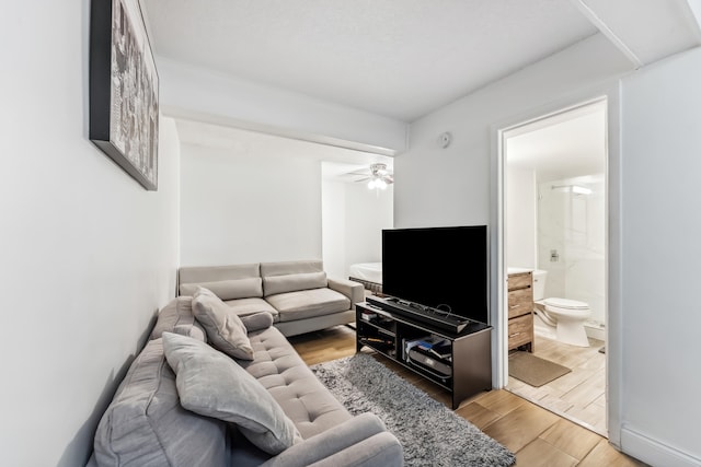 living room with ceiling fan and light wood-style flooring