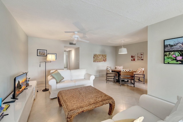 14612 Canalview Dr Unit B, Delray Beach, FL 33484 - living area with a ceiling fan, a textured ceiling, visible vents, and light tile patterned floors