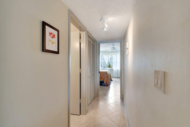 14612 Canalview Dr Unit B, Delray Beach, FL 33484 - hall with baseboards, light tile patterned flooring, and a textured ceiling