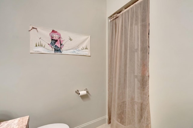 14612 Canalview Dr Unit B, Delray Beach, FL 33484 - bathroom with baseboards, a shower with shower curtain, and toilet