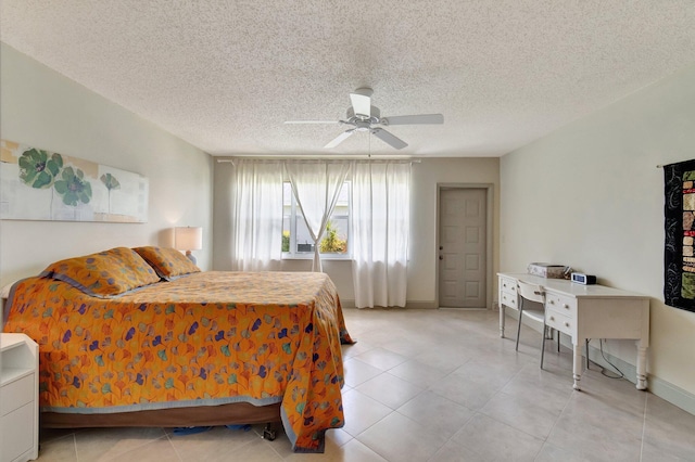 14612 Canalview Dr Unit B, Delray Beach, FL 33484 - bedroom with baseboards, a textured ceiling, ceiling fan, and light tile patterned floors