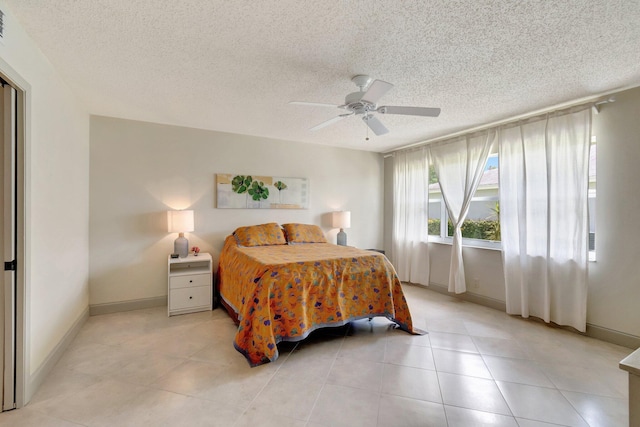 14612 Canalview Dr Unit B, Delray Beach, FL 33484 - bedroom with baseboards, a ceiling fan, a textured ceiling, and light tile patterned flooring