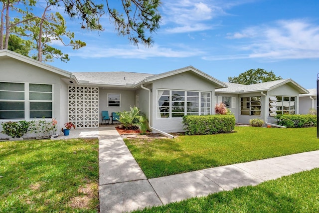 14612 Canalview Dr Unit B, Delray Beach, FL 33484 - ranch-style house featuring stucco siding and a front lawn