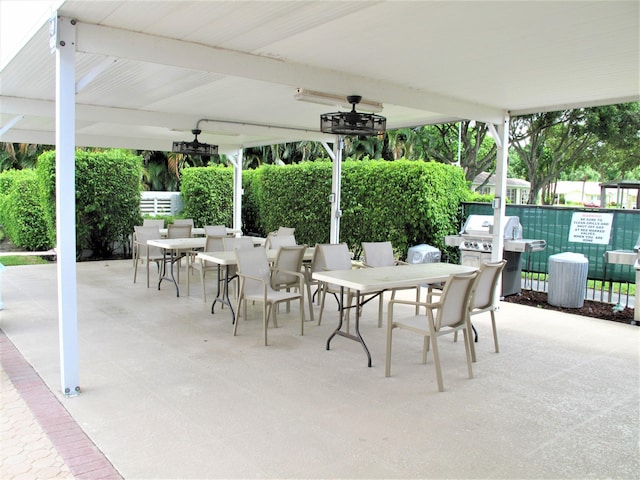 14612 Canalview Dr Unit B, Delray Beach, FL 33484 - view of patio / terrace with fence, outdoor dining space, ceiling fan, and grilling area
