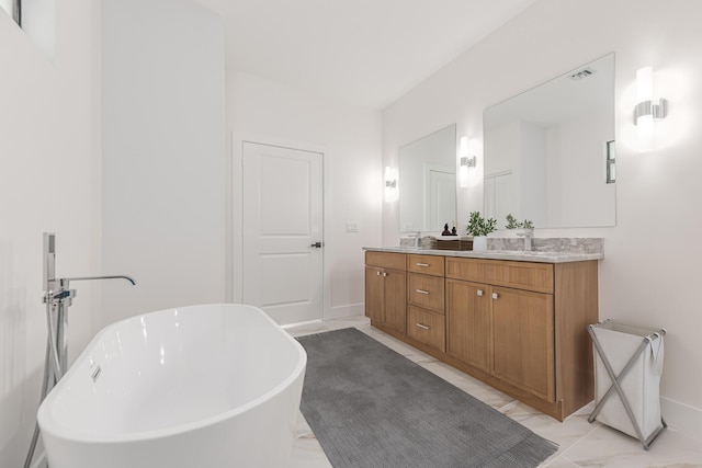 4657 SW Keats St, Port Saint Lucie, FL 34953 - bathroom featuring double vanity, a freestanding bath, and marble look tiles