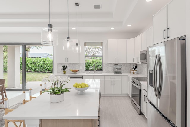 4657 SW Keats St, Port Saint Lucie, FL 34953 - kitchen featuring stainless steel appliances, backsplash, recessed lighting, white cabinetry, and a kitchen island